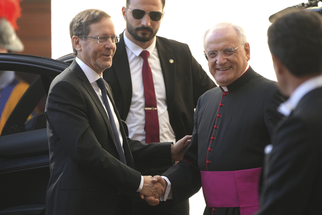 Israel's President Isaac Herzog, left, is greeted by Monsignor Leonardo Sapienza as he arrives in the St. Damasus courtyard at The Vatican on his way to a private audience with Pope Leo XIV, Thursday, Sep. 4, 2025. (AP Photo/Domenico Stinellis)
