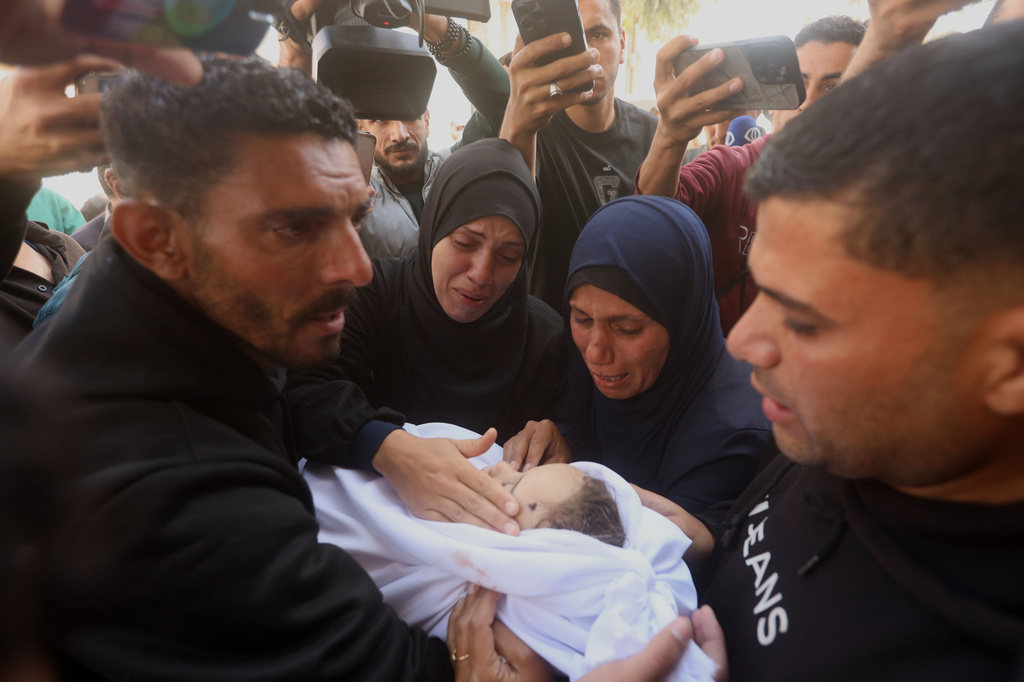 Palestinians mourn over an Al-Tanani family member, killed in an Israeli strike, during their funeral at Al-Shifa Hospital in Gaza City, Saturday, April 25, 2026. (AP Photo/Yousef Alzanoun)