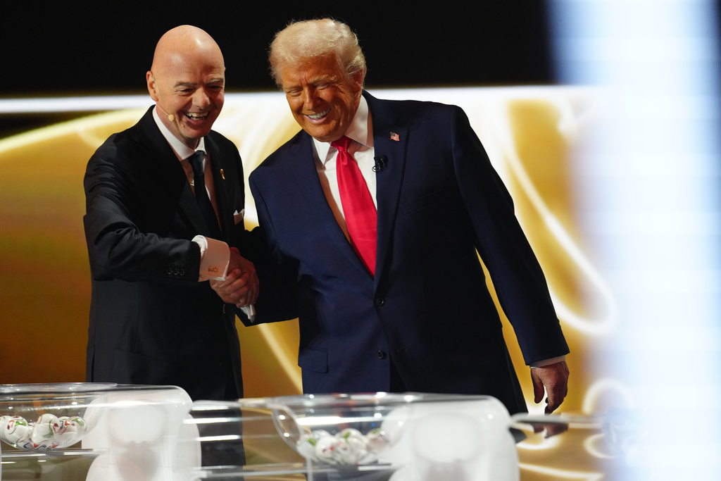President Donald Trump is greeted by FIFA President Gianni Infantino during the draw for the 2026 soccer World Cup at the Kennedy Center in Washington, Friday, Dec. 5, 2025. (Jia Haocheng/Pool Photo via AP)