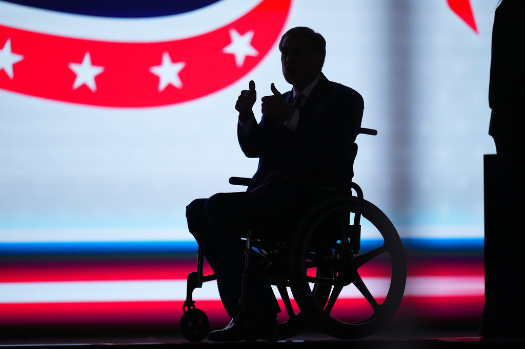 Texas Gov. Greg Abbott is silhouetted on stage at the Republican convention Thursday, Sept. 10, 2026, in Dallas. (AP Photo/Julio Cortez)