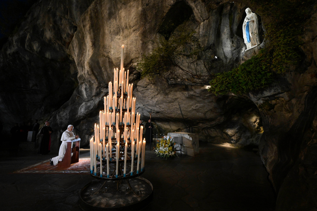 In this handout photo provided by Vatican Media Pope Leo XIV prays at the Grotto of the Apparitions of Massabielle, in Lourdes, France, Saturday, Sept. 26, 2026. (Vatican Media via AP)