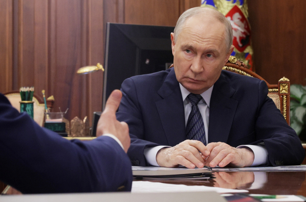 Russian President Vladimir Putin listens to Minister of Industry and Trade Anton Alikhanov during their meeting at the Kremlin in Moscow, Wednesday, Aug. 26, 2026. (Mikhail Metzel, Sputnik, Kremlin Pool Photo via AP)