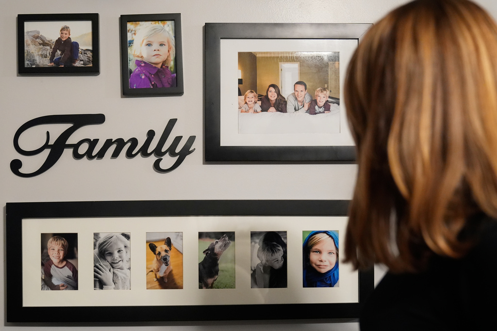 Meaghan Marr looks at photographs of her family's former pets on Thursday, Sept. 25, 2025, in Cartersville, Ga. (AP Photo/Brynn Anderson)