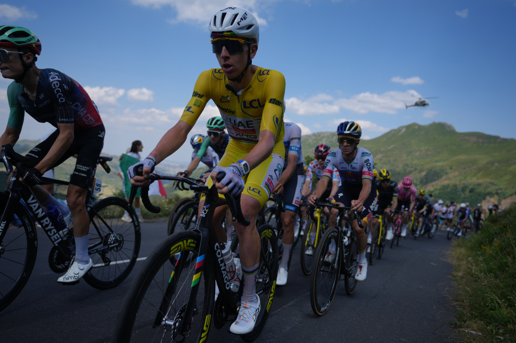 Slovenia's Tadej Pogacar, wearing the overall leader's yellow jersey, rides in the pack during the tenth stage of the Tour de France cycling race with start in Aurillac and finish in Le Lioran, France, Tuesday, July 14, 2026. (AP Photo/Thibault Camus)