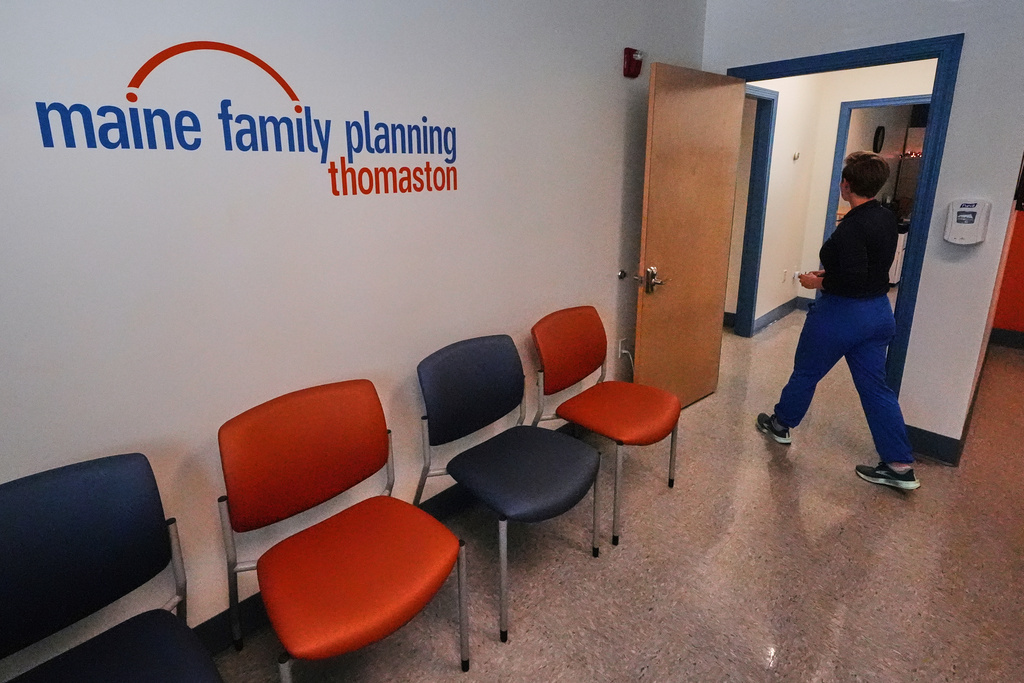 FILE - Vanessa Shields-Haas, a nurse practitioner, walks from the lobby toward the examination rooms at the Maine Family Planning healthcare facility, July 15, 2025, in Thomaston, Maine. (AP Photo/Charles Krupa, file)