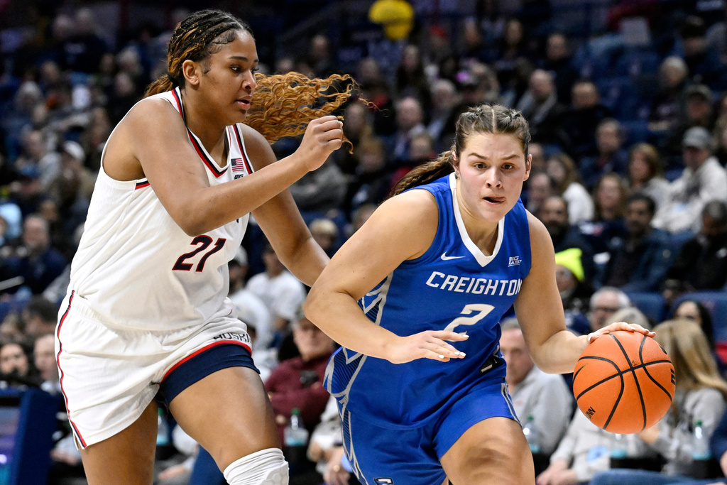UConn forward Sarah Strong (21) guards Creighton guard Kennedy Townsend (2) in the first half of an NCAA college basketball game, Wednesday, Feb. 11, 2026, in Storrs, Conn. (AP Photo/Jessica Hill)