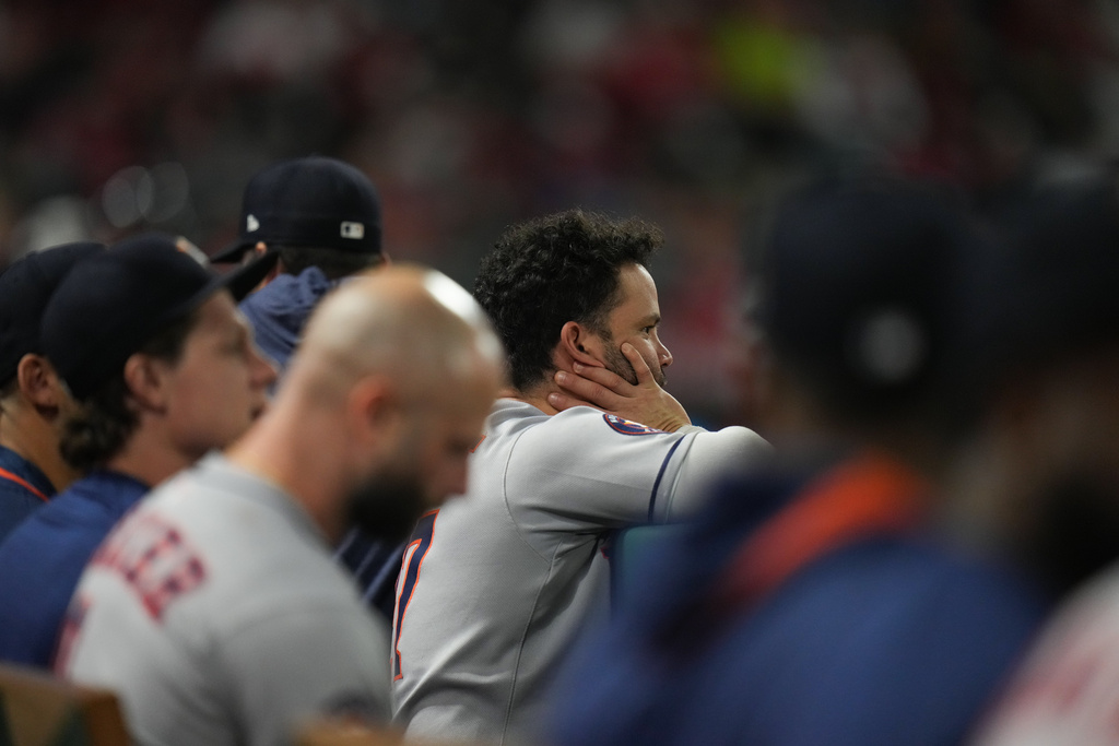 Houston Astros' Jose Altuve, center, and his teammates watch from the dugout during the fifth inning of a baseball game against the Los Angeles Angels Saturday, Sept. 27, 2025, in Anaheim, Calif. (AP Photo/Jae C. Hong)