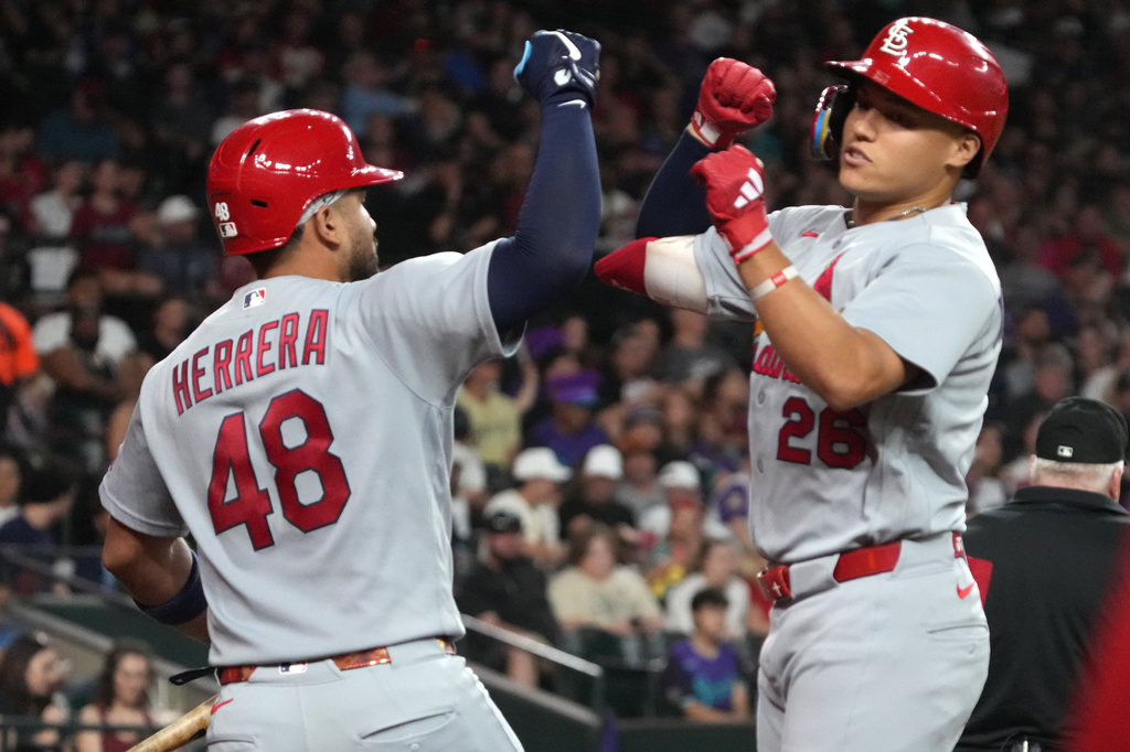 St. Louis Cardinals' JJ Wetherholt celebrates with Iván Herrera (48) after hitting a solo home run against the Arizona Diamondbacks in the fifth inning of a baseball game, Friday, July 17, 2026, in Phoenix. (AP Photo/Rick Scuteri)
