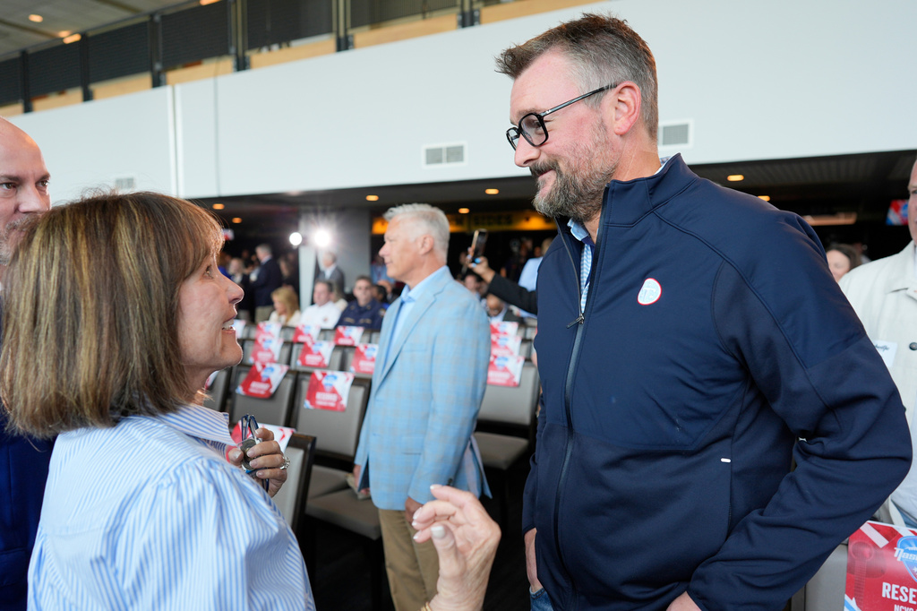 Tennessee Titans controlling owner Amy Adams Strunk, left, speaks with Country music artist Eric Church, right, before a news conference Wednesday, May 20, 2026, celebrating that the 2030 Super Bowl will be held at the NFL football team's Nissan Stadium in Nashville, Tenn. (AP Photo/George Walker IV)