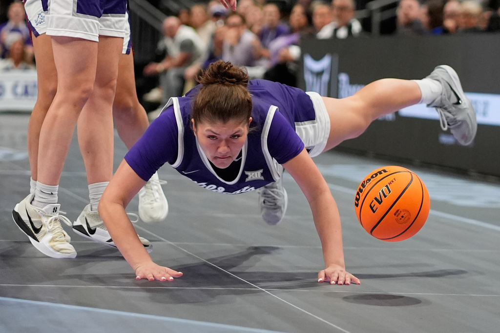 Kansas State's Jordan Speiser chases a loose ball during first half of an NCAA college basketball game against TCU, in the semifinals of the Big 12 Conference tournament Saturday, March 7, 2026, in Kansas City, Mo. (AP Photo/Charlie Riedel)