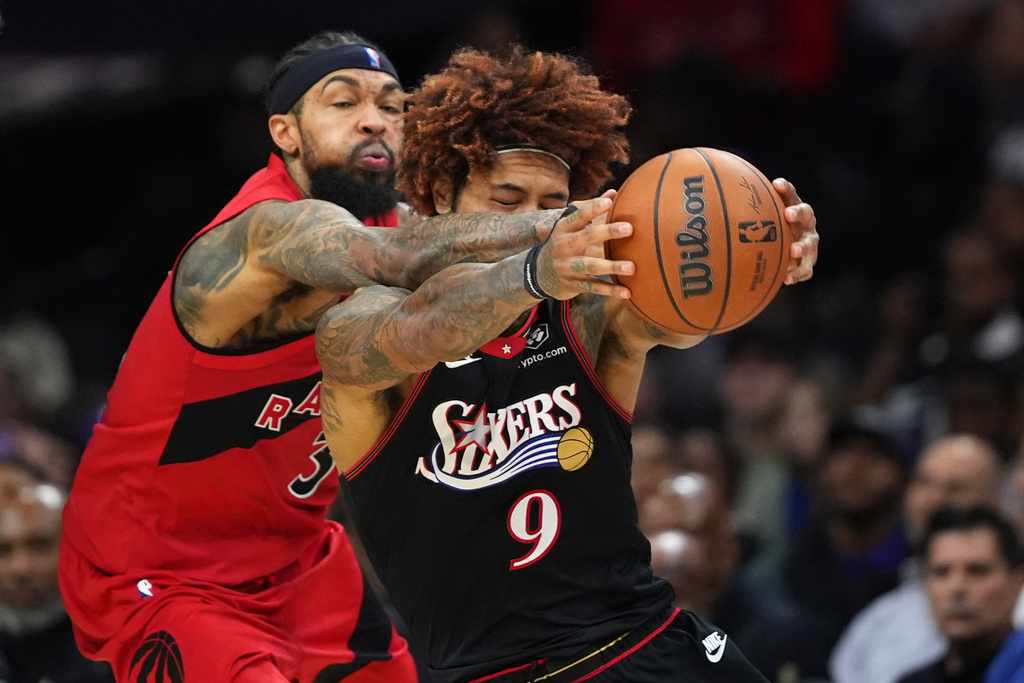 Philadelphia 76ers' Kelly Oubre Jr., right, and Toronto Raptors' Brandon Ingram battle for the ball during the second half of an NBA basketball game Saturday, Nov. 8, 2025, in Philadelphia. (AP Photo/Matt Slocum)