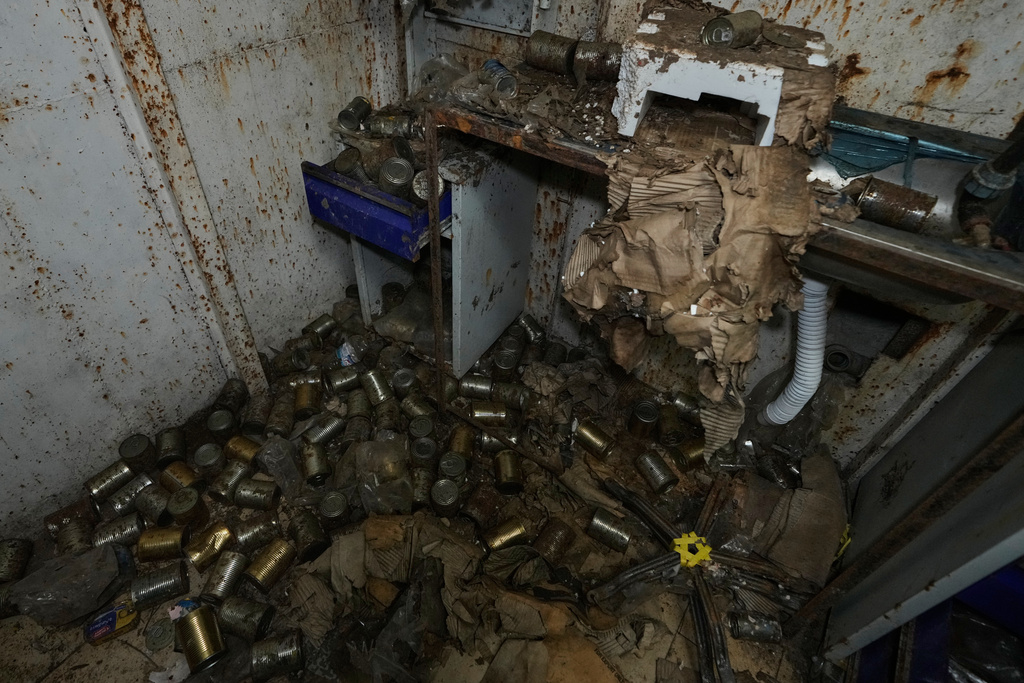 Boxes of canned food are scattered inside one of the rooms of the tunnel dug into a mountain that was used by Hezbollah militants as a clinic and storage facility, near the Lebanese-Israeli border in the Zibqin Valley, southern Lebanon, Friday, Nov. 28, 2025. (AP Photo/Bilal Hussein)