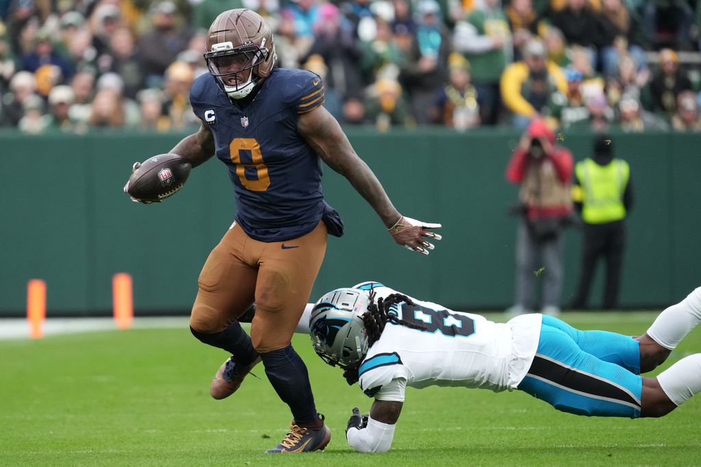 Green Bay Packers running back Josh Jacobs, left, runs against Carolina Panthers cornerback Jaycee Horn, right, during the second half of an NFL football game Sunday, Nov. 2, 2025, in Green Bay, Wis. (AP Photo/Morry Gash)