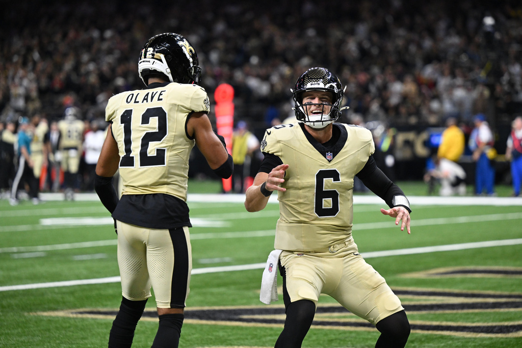 New Orleans Saints wide receiver Chris Olave, left, celebrates with quarterback Tyler Shough (6) after scoring a touchdown during the second half of an NFL football game against the New York Jets, Sunday, Dec. 21, 2025, in New Orleans. (AP Photo/Ella Hall)