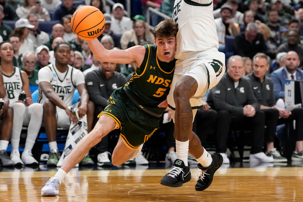 North Dakota State guard Andy Stefonowicz (5) drives past Michigan State forward Coen Carr (55) during the first half in the first round of the NCAA college basketball tournament, Thursday, March 19, 2026, in Buffalo, N.Y. (AP Photo/Yuki Iwamura)