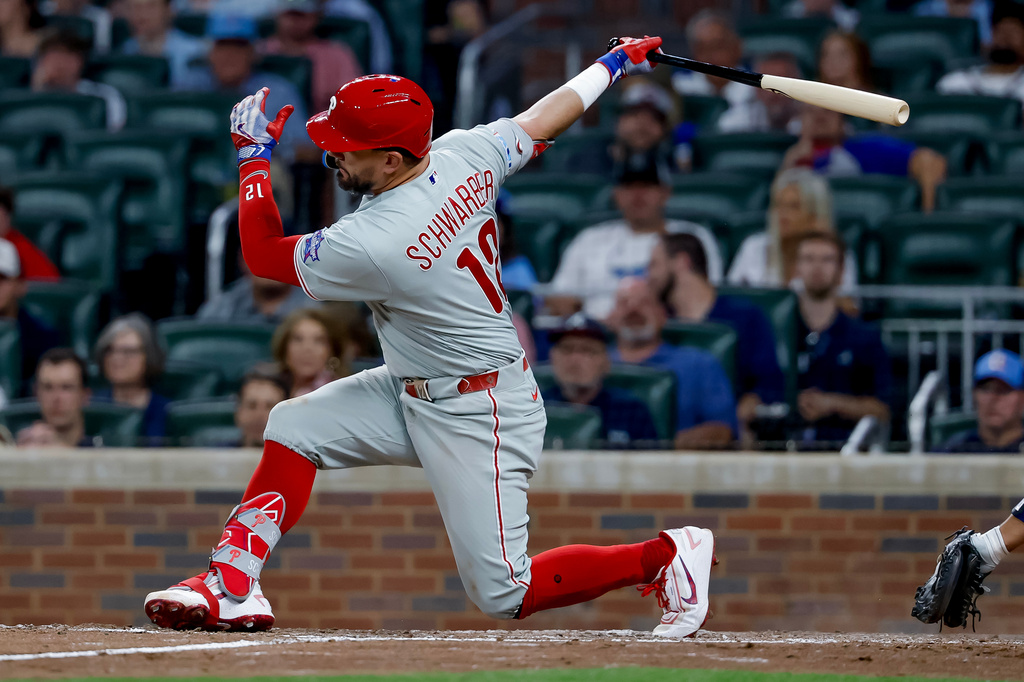 Philadelphia Phillies designated hitter Kyle Schwarber (12) strikes out with men on base against the Atlanta Braves during the ninth inning of a baseball game, Friday, April 24, 2026, in Atlanta. (AP Photo/Erik S. Lesser)