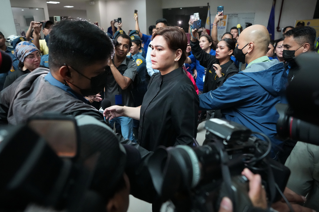 Philippine Vice President Sara Duterte leaves after posting bail at the Quezon city justice hall, Philippines, Saturday, Sept. 5, 2026, after a warrant of arrest on charges that she publicly threatened to arrange the assassination of President Ferdinand Marcos Jr. and two other people. (AP Photo/Aaron Favila)