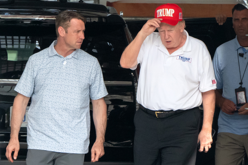 President Donald Trump, right, walks at the North Portico of the White House, Saturday, July 11, 2026, in Washington. (AP Photo/Mark Schiefelbein)
