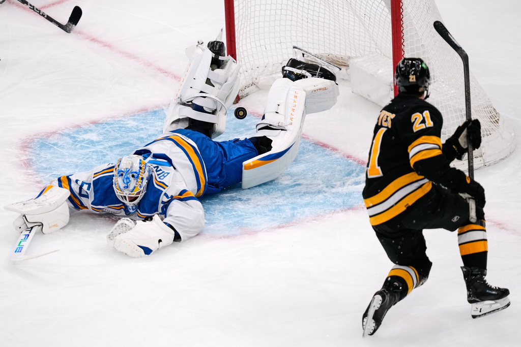 St. Louis Blues goaltender Jordan Binnington, left, drops to the ice after Boston Bruins center Alex Steeves (21) scored during the first period of an NHL hockey game, Thursday, Dec. 4, 2025, in Boston. (AP Photo/Charles Krupa)