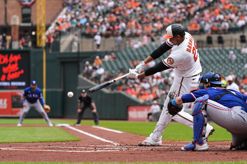 Baltimore Orioles' Samuel Basallo (29) hits a single during the first inning of a baseball game against the Texas Rangers, Wednesday, April 1, 2026, in Baltimore. (AP Photo/Stephanie Scarbrough)