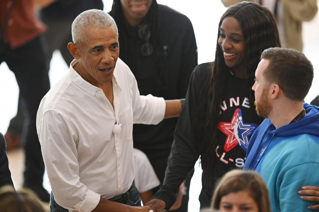 Former President Barack Obama, left, jokes around with WNBA All-Star Jackie Young, right, during a practice at the Obama Presidential Center in Chicago, Friday, July 24, 2026. (AP Photo/Paul Beaty)