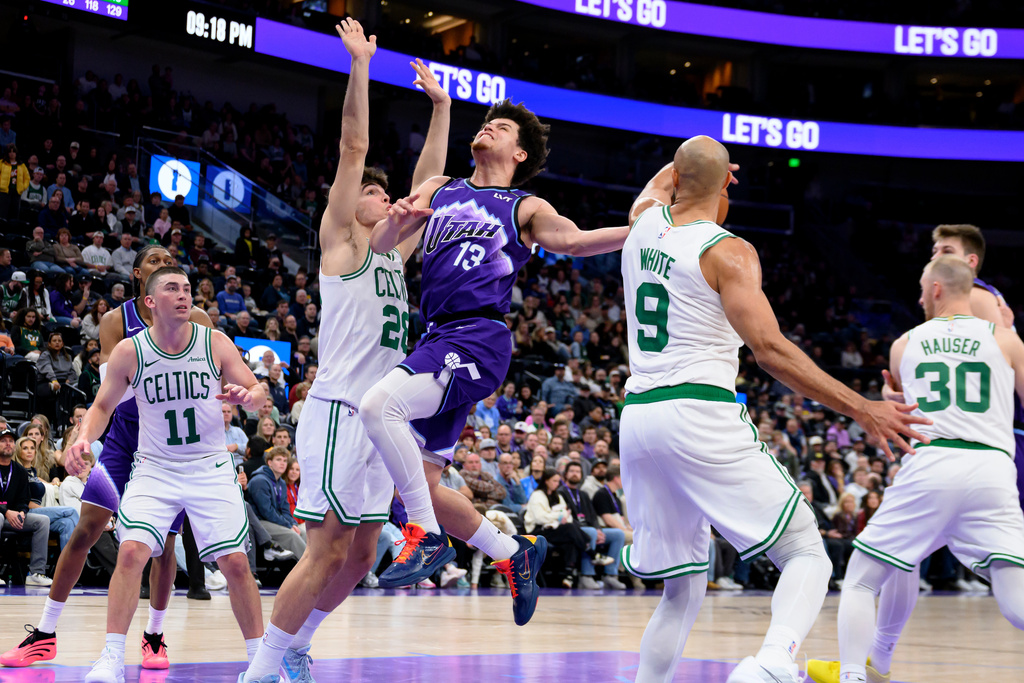 Boston Celtics guard Derrick White (9) steals the ball away from Utah Jazz guard Walter Clayton Jr. (13) as he was driving to the basket during the second half of an NBA basketball game, Tuesday, Dec. 30, 2025, in Salt Lake City. (AP Photo/Tyler Tate)