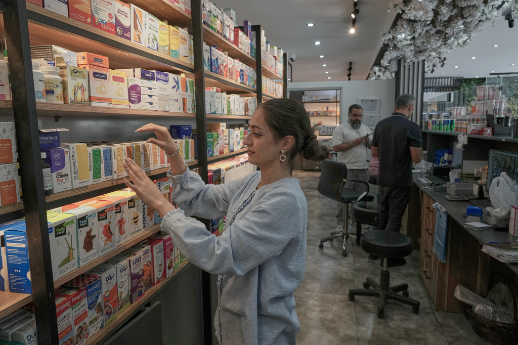 A pharmacy technician arranges boxes of medicine at a pharmacy in Tehran, Iran, Monday, Sept. 21, 2026. (AP Photo/Vahid Salemi)