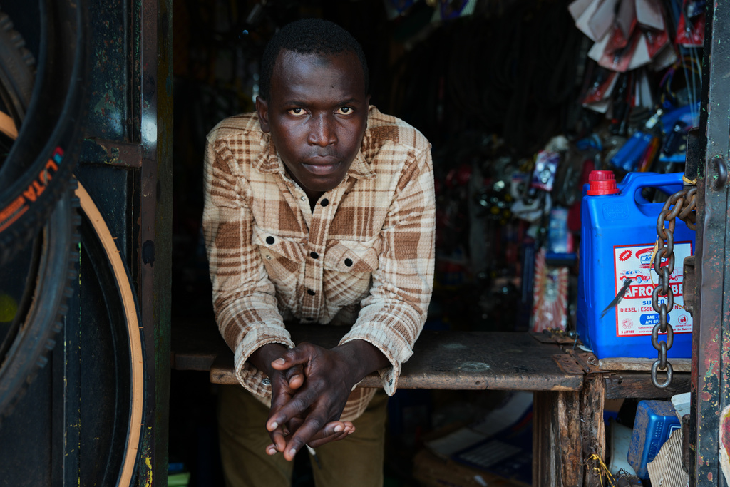 Oumar Bella Diallo, a returnee, poses for a portrait at his workplace in Conakry, Guinea, Sept. 23, 2025. (AP Photo/Misper Apawu)