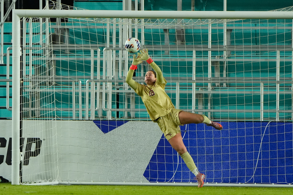 Florida State goalkeeper Kate Ockene knocks away a shot during the second half of the NCAA college soccer tournament final against Stanford Monday, Dec. 8, 2025, in Kansas City, Mo. (AP Photo/Charlie Riedel)