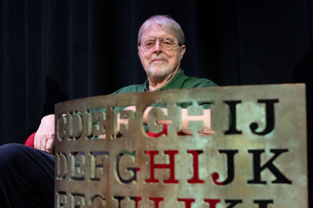 Artist Jim Sanborn sits behind a proof of concept piece for the Kryptos sculpture during a press conference at the International Spy Museum, Wednesday, Nov. 12, 2025 in Washington. (AP Photo/Kevin Wolf)