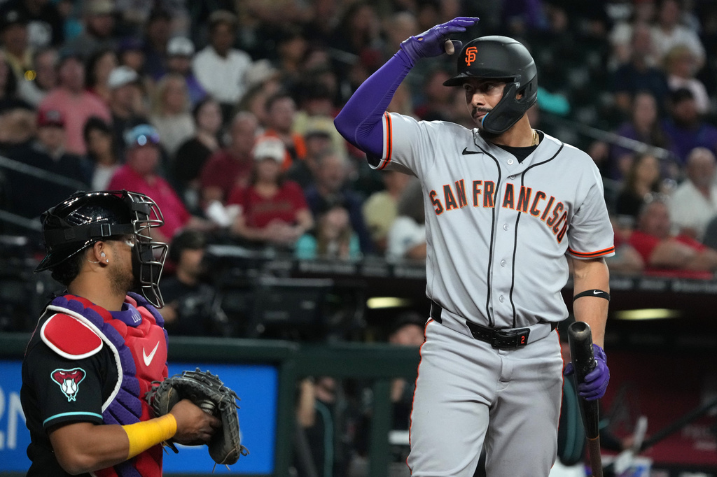 San Francisco Giants' Willy Adames, right, asks for a challenge against the Arizona Diamondbacks in the eighth inning of a baseball game, Tuesday, May 19, 2026, in Phoenix. (AP Photo/Rick Scuteri)