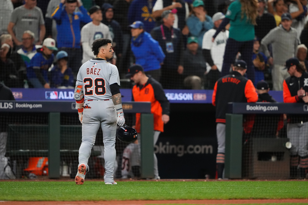 Detroit Tigers center fielder Javier Báez (28) walks to the dugout after popping out to end the top of the 14th inning in Game 5 of baseball's American League Division Series against the Seattle Mariners, Friday, Oct. 10, 2025, in Seattle. (AP Photo/Lindsey Wasson)