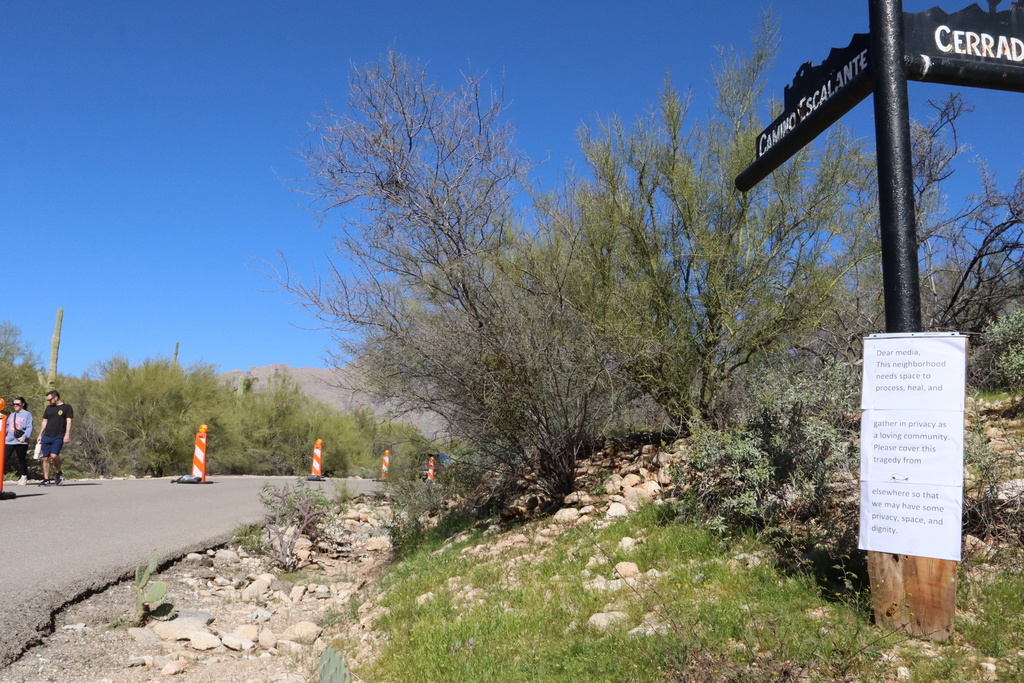 A sign posted along the road to Nancy Guthrie's home on Sunday, Feb. 22, 2026, in Tucson, Ariz., asks media to work elsewhere. (AP Photo/Felicia Fonseca)