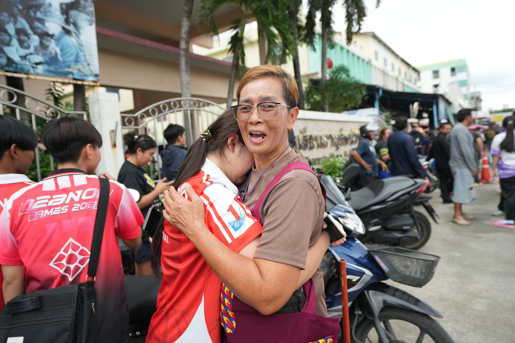A schoolgirl cries outside her school where deaths and injuries were reported after a shooting in Thailand's Nonthaburi province, Friday, Aug. 7, 2026. (AP Photo/Sakchai Lalit)