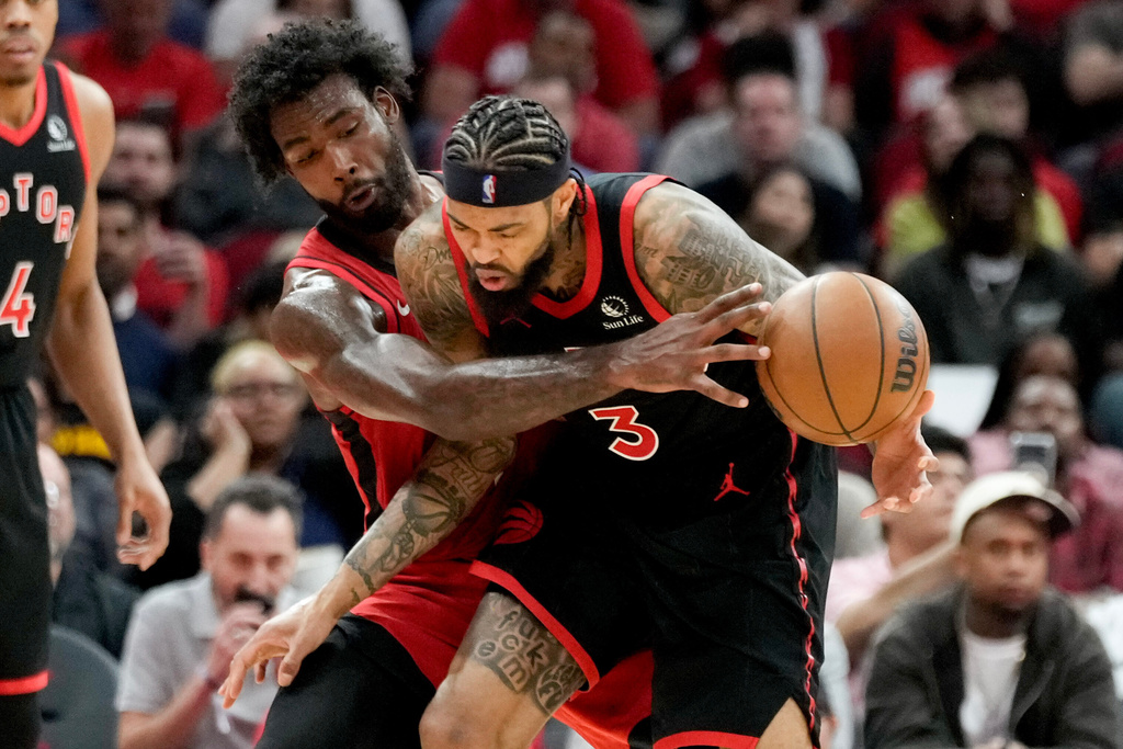 Houston Rockets forward Tari Eason, left, attempts to steal the ball from Toronto Raptors forward Brandon Ingram during the first half of an NBA basketball game Tuesday, March 10, 2026, in Houston. (AP Photo/Eric Christian Smith)