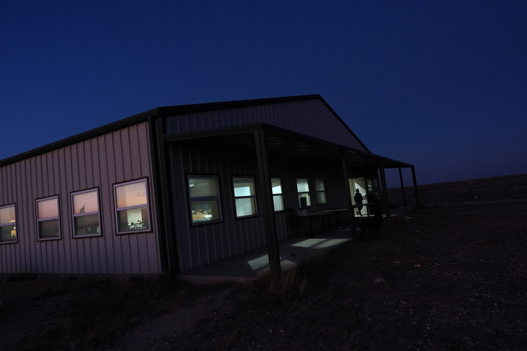 A Mayflower Church member walks out of the community's main hall, used for religious education and recreation, in Midland, Texas, Jan. 18, 2025. (AP Photo/Rebecca Blackwell)