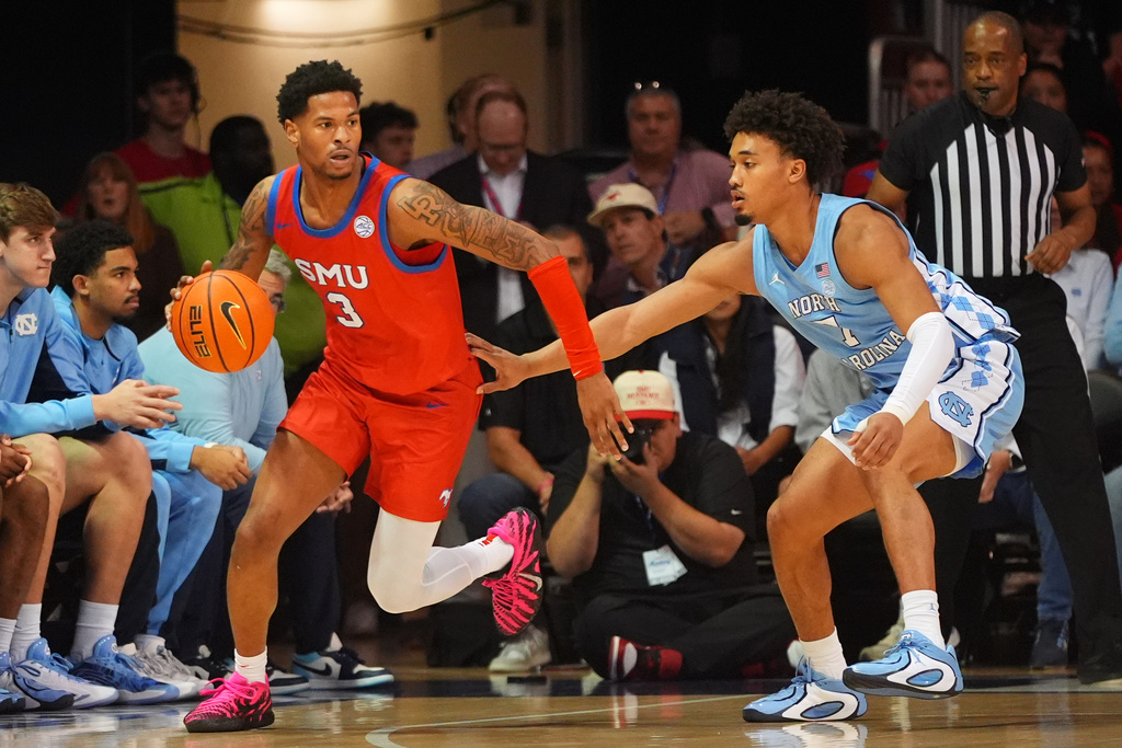 SMU forward Corey Washington (3) dribbles against North Carolina guard Seth Trimble (7) during the first half of an NCAA college basketball game Saturday, Jan. 3, 2026, in Dallas. (AP Photo/LM Otero)