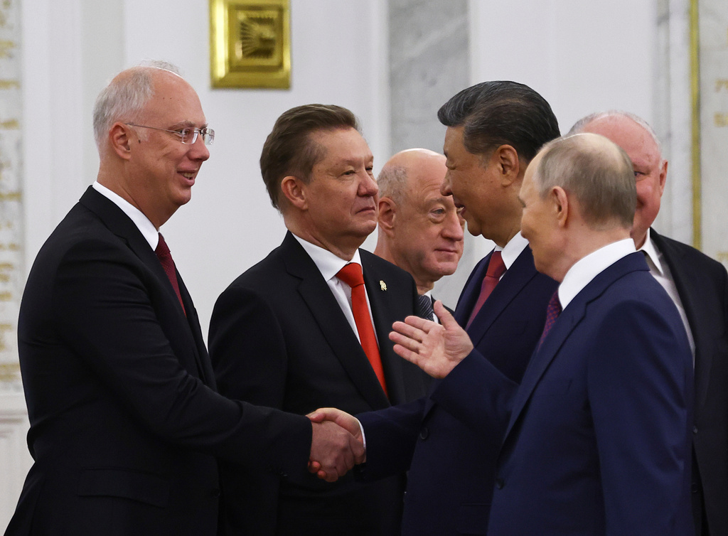 FILE - Chinese President Xi Jinping shakes hands with Kirill Dmitriev, the head of the Russian Direct Investment Fund, as Russian President Vladimir Putin looks on in Moscow, on May 8, 2025. (Evgenia Novozhenina/ Pool Photo via AP, File)