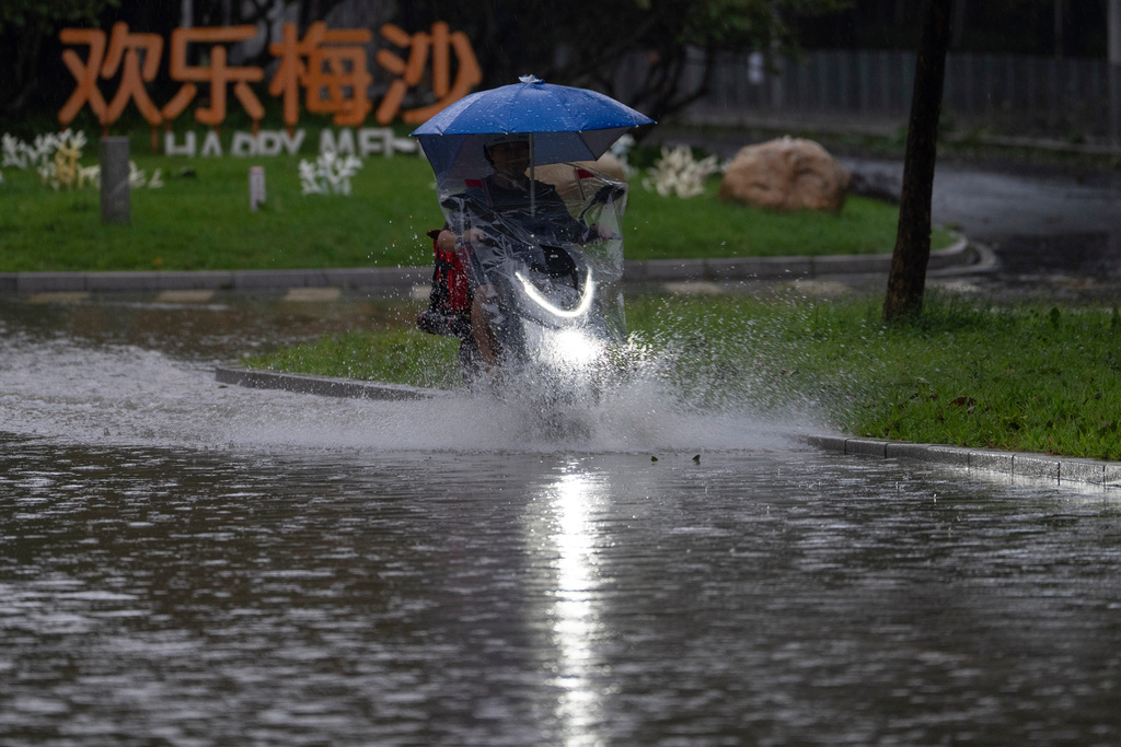 A cyclist rides through flood waters in the aftermath of Super Typhoon Ragasa in Shenzhen in southern China's Guangdong province on Wednesday, Sept. 24, 2025. (AP Photo/Ng Han Guan)