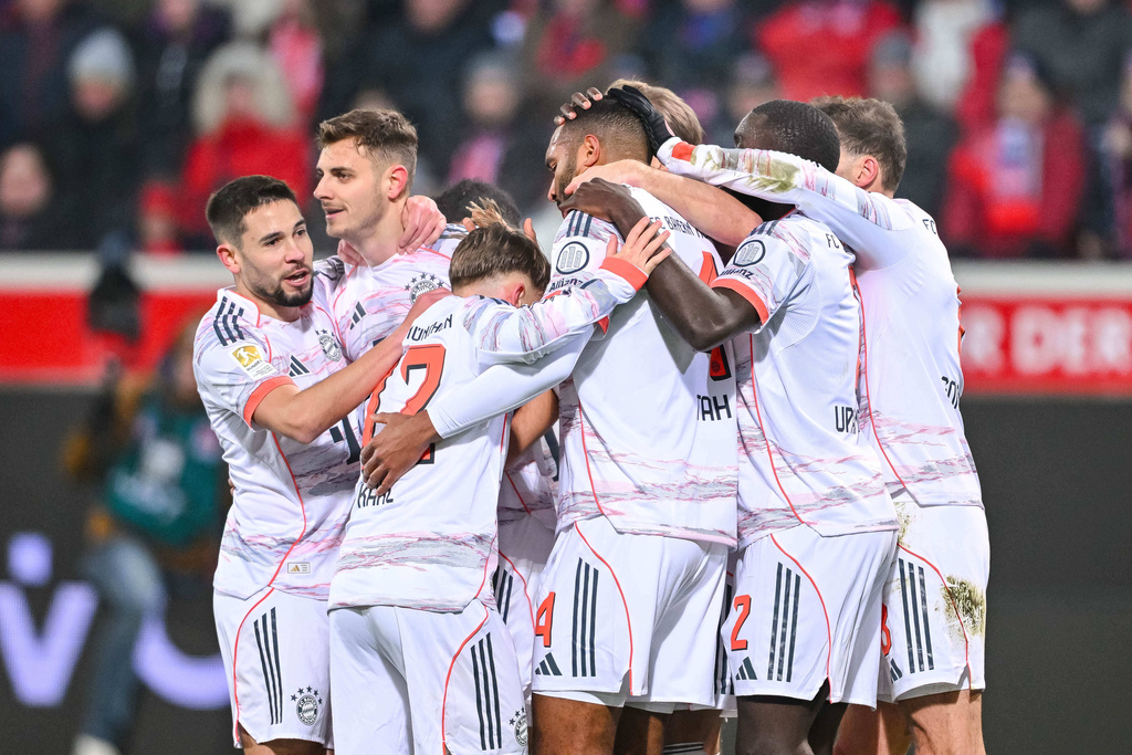 Bayern's Josip Stanisic celebrates with teammates after scoring their side's first goal of the game during the Bundesliga soccer match between FC Heidenheim and Bayern Munich, in Heidenheim, Germany, Sunday Dec. 21, 2025. (Harry Langer/dpa via AP)