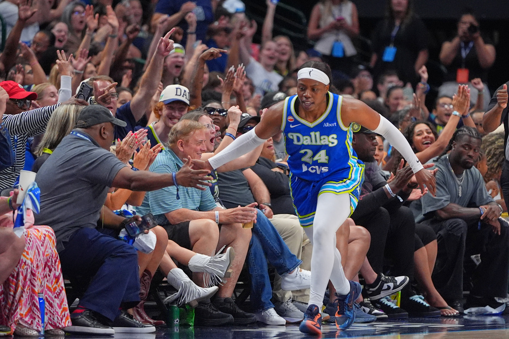 Dallas Wings guard Arike Ogunbowale (24) celebrates after scoring a 3-point basket during the first half of a WNBA basketball game against the Chicago Sky in Dallas, Sunday, July 12, 2026. (AP Photo/LM Otero)