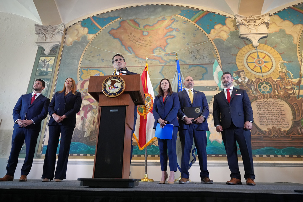 Acting Attorney General Todd Blanche, center, speaks after federal prosecutors announced charges against former Cuban President Raul Castro in the 1996 downing of civilian planes operated by Miami-based exiles, Wednesday, May 20, 2026, in Miami. Also speaking at the event, were, from left, Florida Attorney General James Uthmeier, Miami Dade College President Madeline Pumariega, Sen. Ashley Moody, R-Fla., FBI Deputy Director Christopher Raia, and Jason A. Reding Quiñones, U.S. attorney for the southern district of Florida. (AP Photo/Rebecca Blackwell)