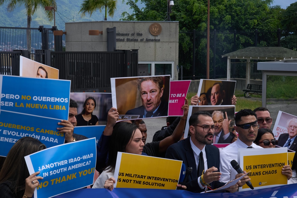 Gabriel Cabrera, president of the Venezuelan Youth Center for Democracy, gives a statement outside of the U.S. embassy with members of the organization holding signs against U.S. intervention, in reference to U.S. warships operating in the Caribbean, in Caracas, Venezuela, Monday, Oct. 27, 2025. (AP Photo/Ariana Cubillos)