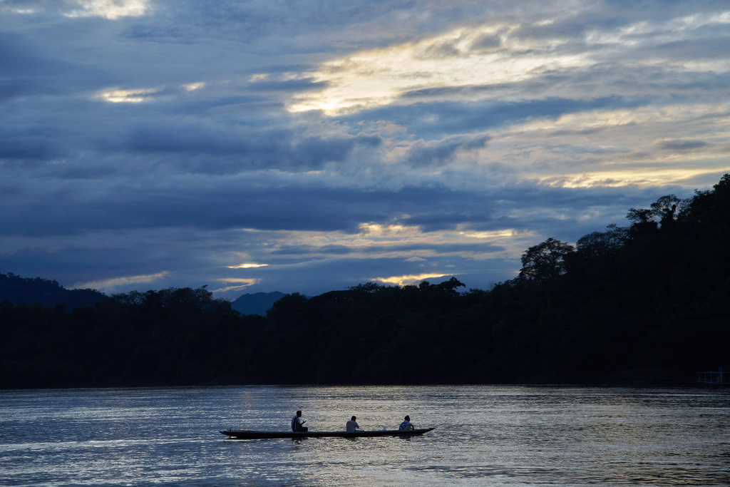 A longtail boat crosses the Mekong River at sunset under heavy clouds in Luang Prabang, Laos, Monday, Nov. 3, 2025. (AP Photo/Eugene Hoshiko)