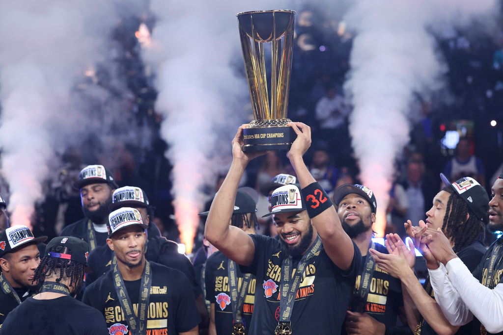 New York Knicks center Karl-Anthony Towns (32) celebrates with teammates after his team's victory against the San Antonio Spurs in the NBA Cup championship basketball game Tuesday, Dec. 16, 2025, in Las Vegas. (AP Photo/Ian Maule)