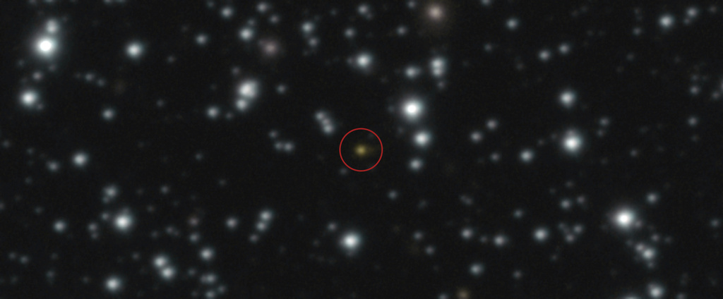 This image provided by the European Southern Observatory shows a powerful explosion, orange dot at the center of the image, that repeated several times over the course of a day, The image, taken with ESO's Very Large Telescope (VLT), allowed astronomers to determine that the explosion didn't take place in the Milky Way but in another galaxy. (European Southern Observatory via AP)