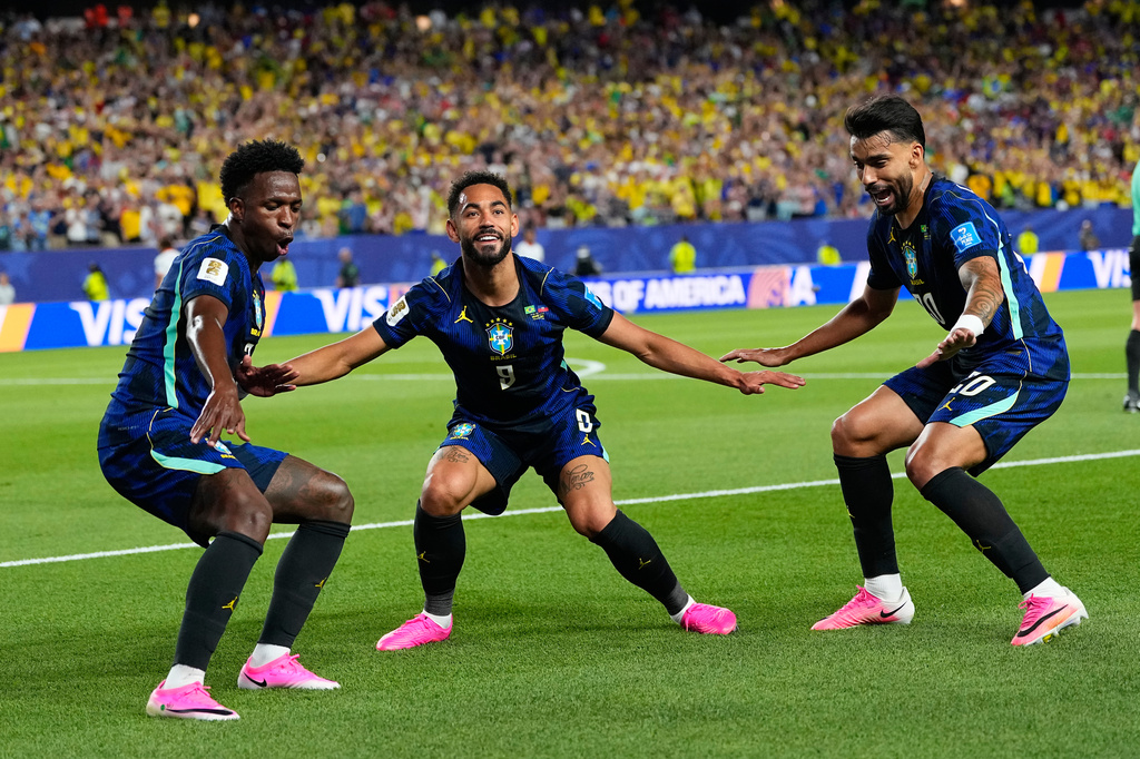 Brazil's Matheus Cunha (9) celebrates after scoring his side's second goal with Brazil's Vinicius Junior (7) and Lucas Paqueta (20) during the World Cup Group C soccer match between Brazil and Haiti in Philadelphia, Friday, June 19, 2026. (AP Photo/Petr David Josek)