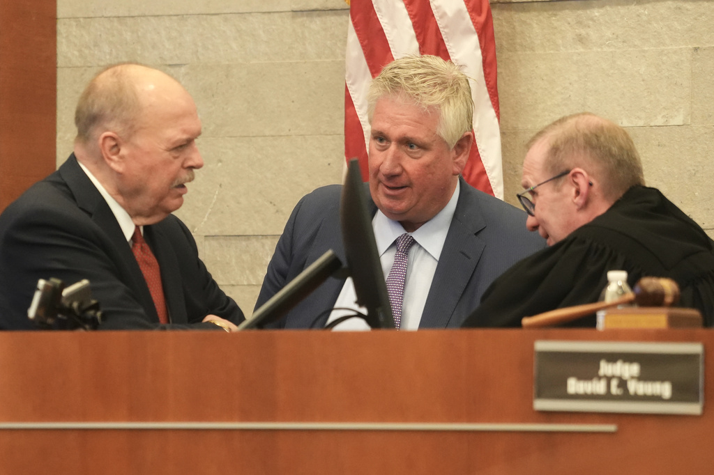 Special prosecutor Tim Merkle, left, talks with defense attorney Mark Collins and Judge David Young speak during closing arguments in former sheriff's deputy Jason Meade's retrial inside Franklin County Court of Common Pleas on Wednesday, May 6, 2026, in Columbus, Ohio. (Doral Chenoweth/The Columbus Dispatch via AP, Pool)