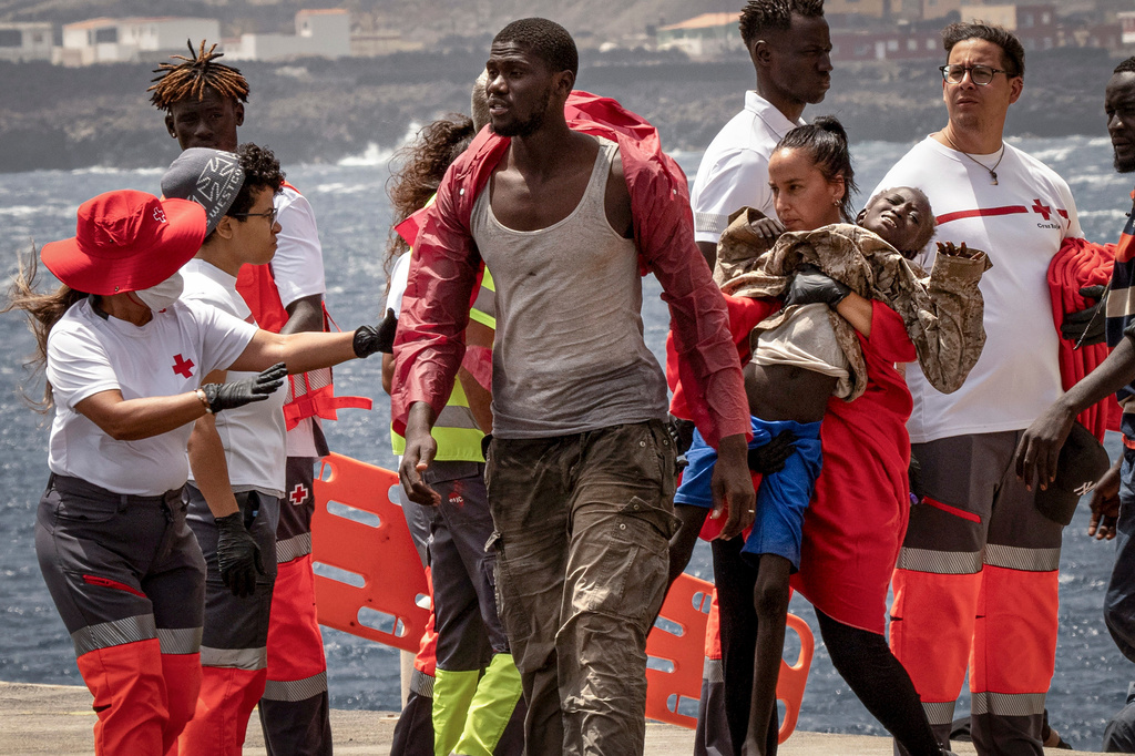 FILE - Migrants disembark at the port of "La Estaca" in Valverde on the Canary island of El Hierro, Spain, Aug. 26, 2024. Emergency services said the migrants arrived by boat after a 13-day voyage from Senegal. (AP Photo/Maria Ximena, File)