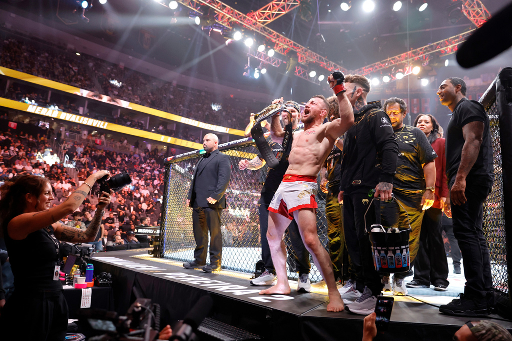 UFC bantamweight champion Merab Dvalishvili, of Georgia, celebrates after defeating Cory James Sandhagen, of the United States, during UFC 320 Saturday, Oct. 4, 2025, in Las Vegas. (Steve Marcus/Las Vegas Sun via AP)